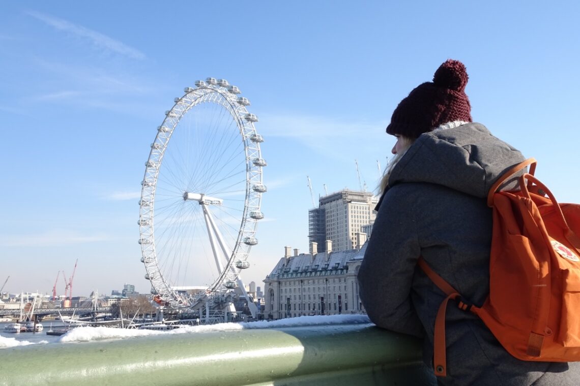 Gemma standing on Westminster Bridge looking at London Eye