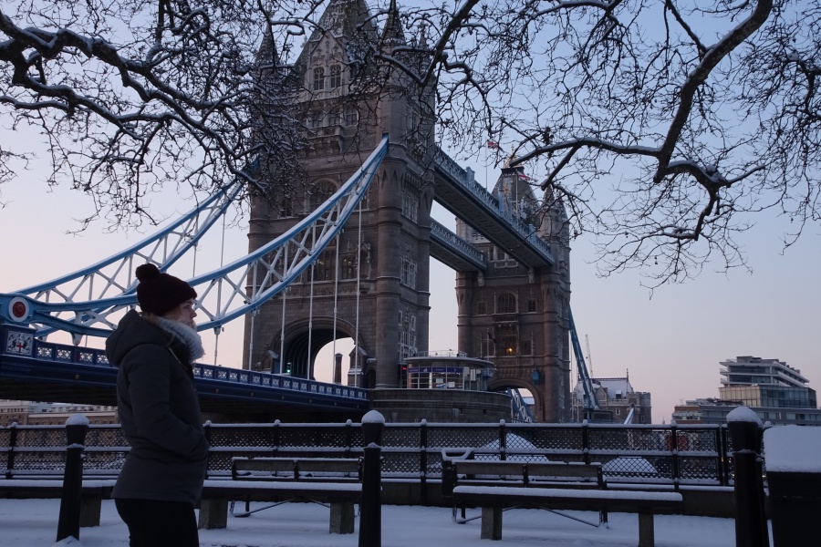Gemma standing overlooking Tower Bridge in the snow.
