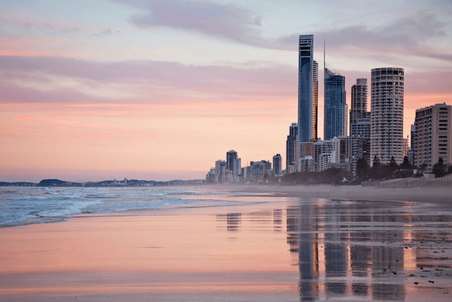 An Australian Beach with a pink sky at sunset