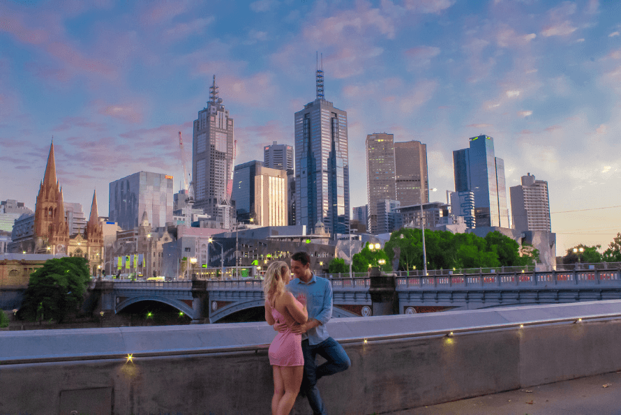 A couple standing in Melbourne with the city view at sunrise