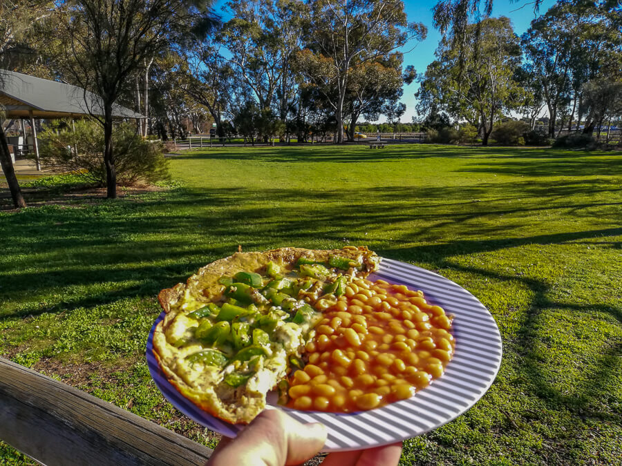 an omelette with peppers and cheese on a side of beans