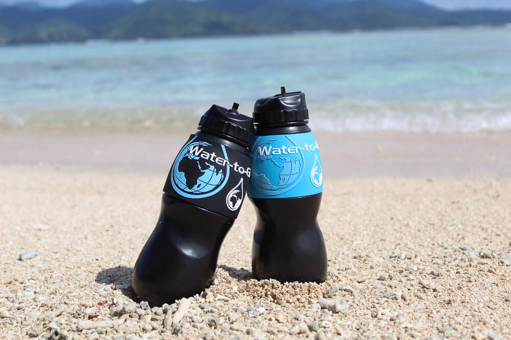 watertogo waterbottles on a beach