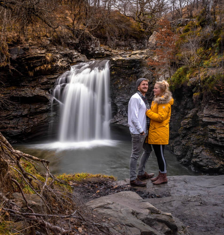 gemma and campbell in front of waterfall