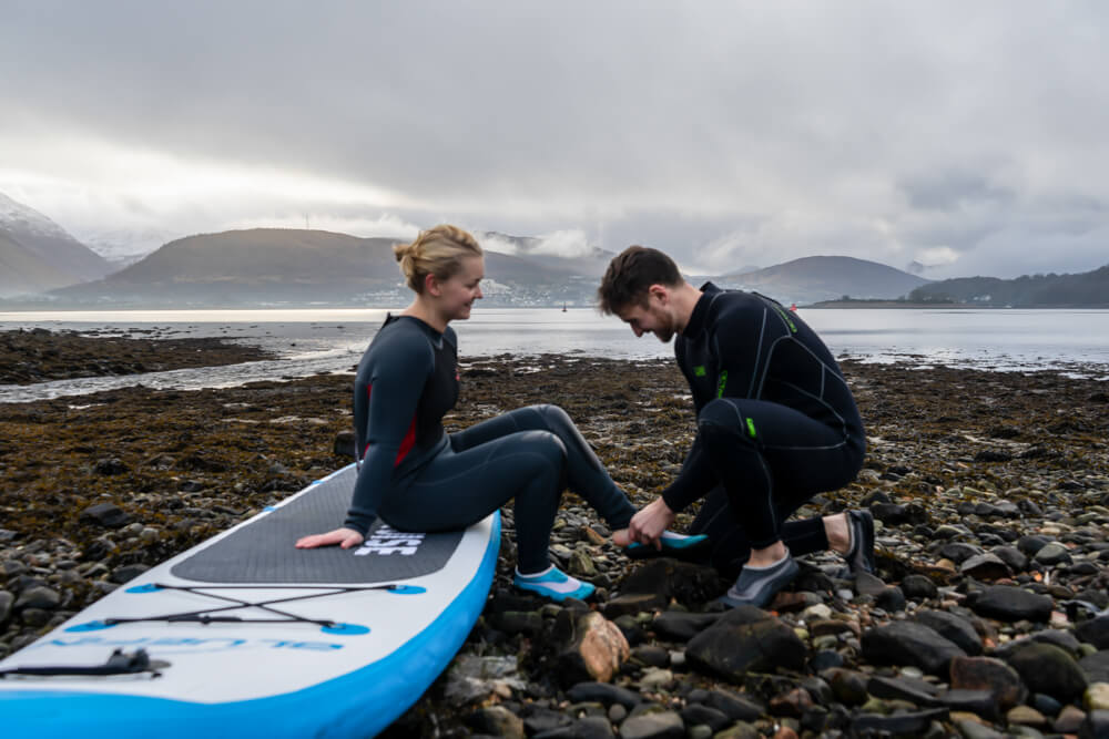 Getting a wetsuit on before an SUP adventure.