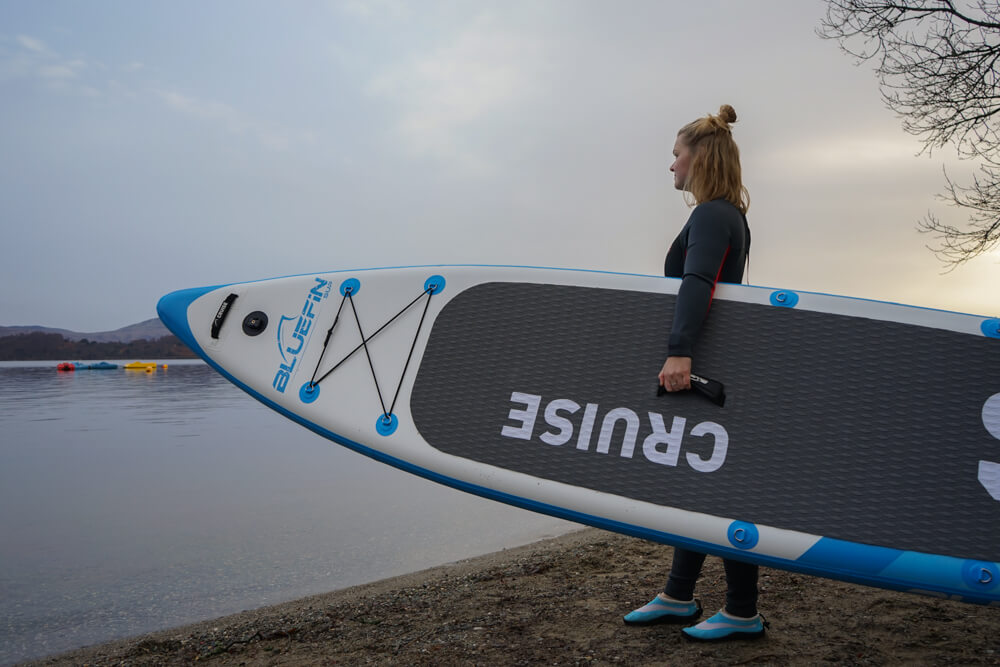 Gemma holding an SUP.