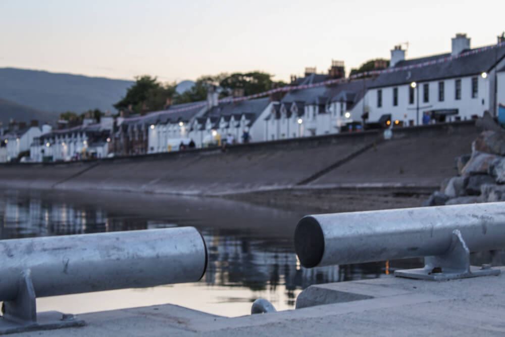 The white houses of Ullapool high street from the pier.