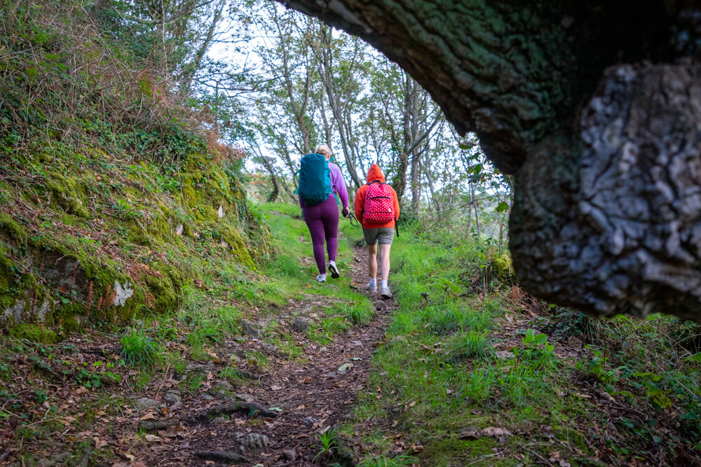 2 girls walking round the cliff to Marble Bay Guernsey