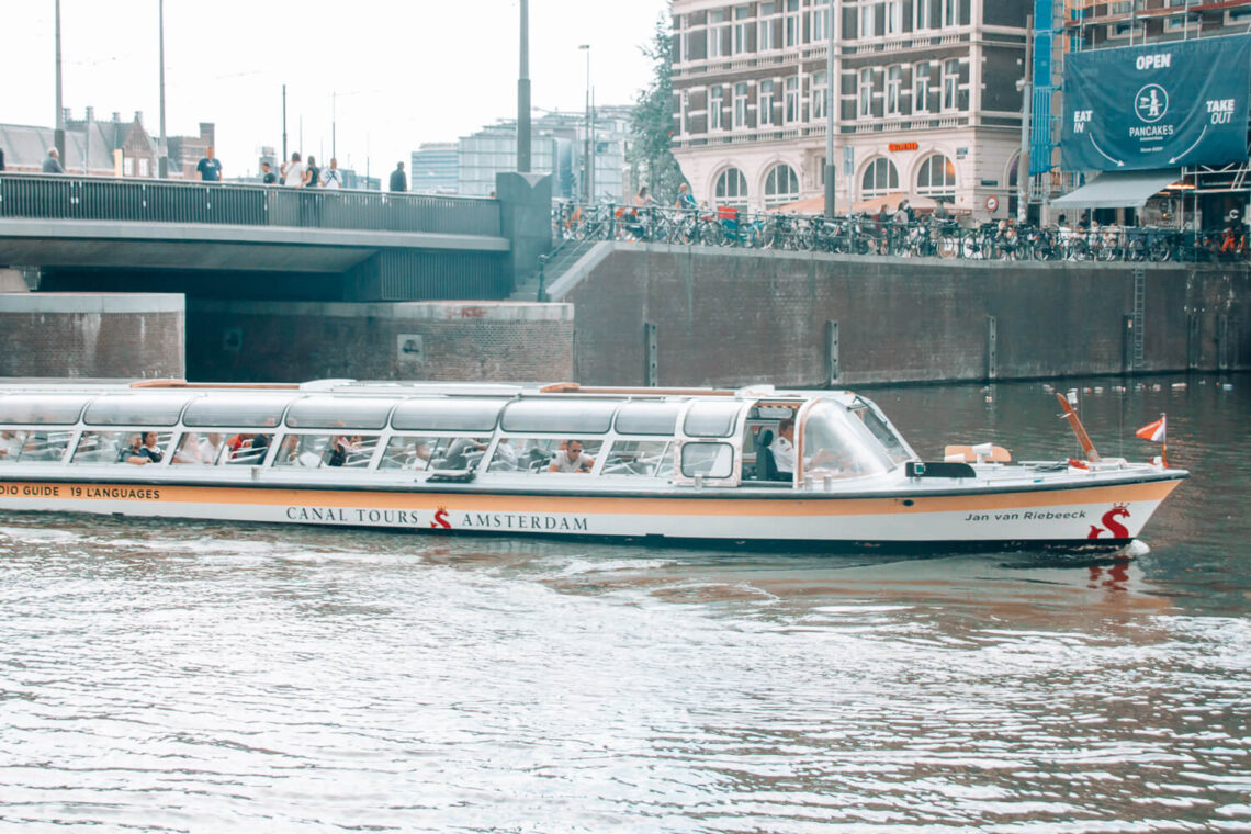 Boat cruising on the canal in Amsterdam