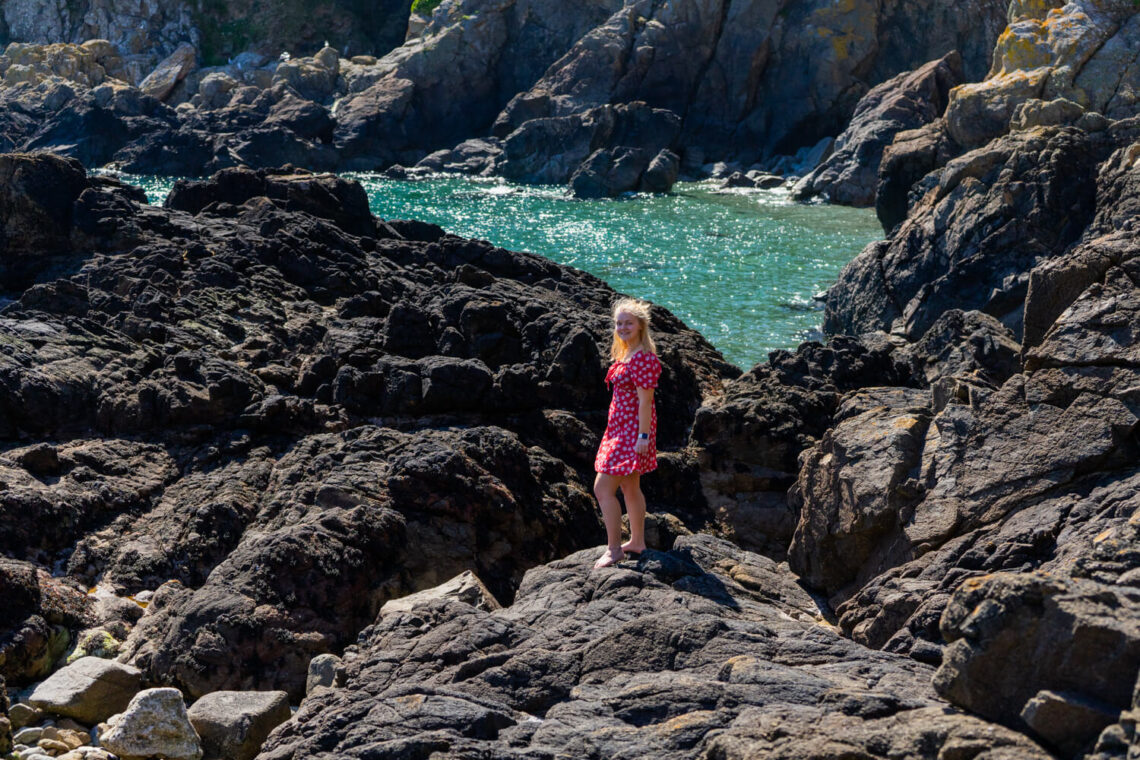 Gemma standing on the rocks at Jerbourg Point