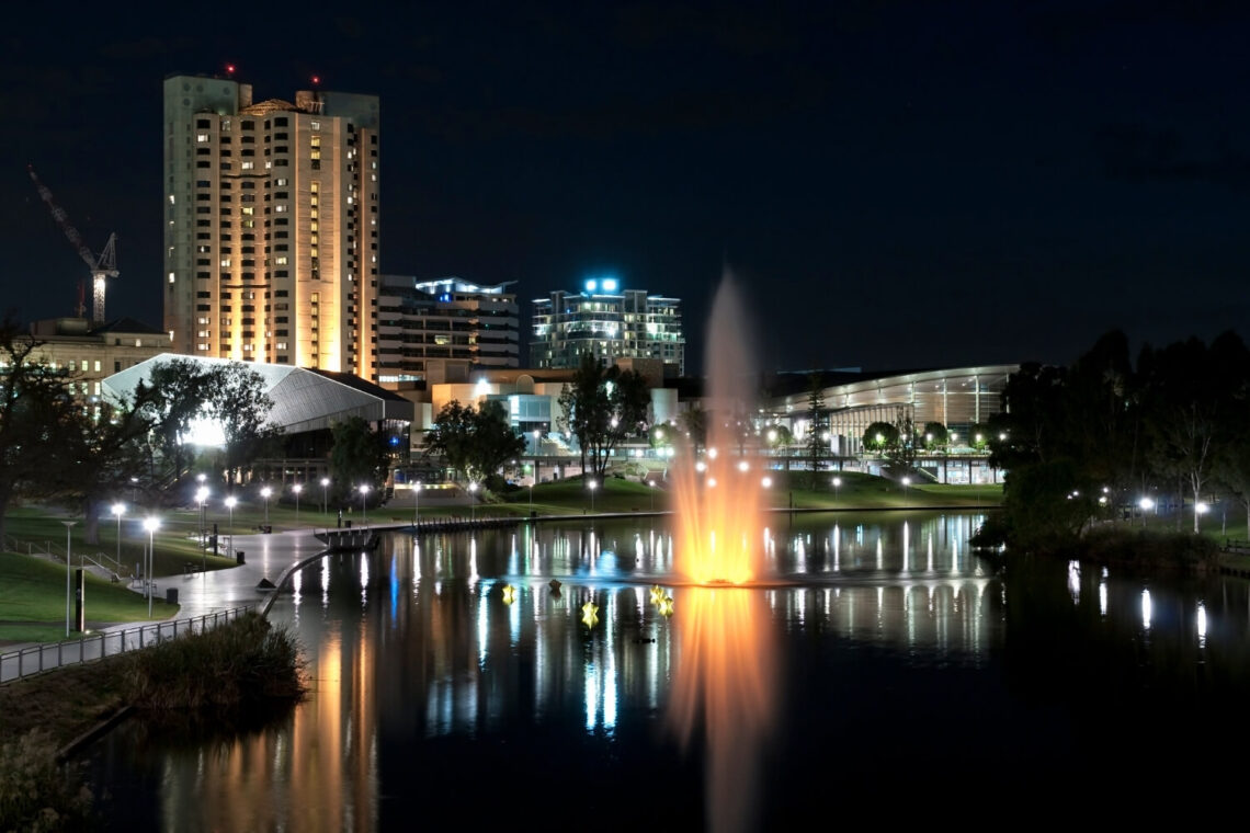 adelaide at night with reflections of the buildings on water