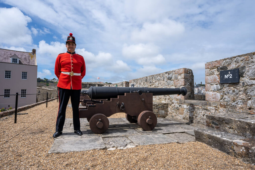 soldier in front of canon at castle cornet