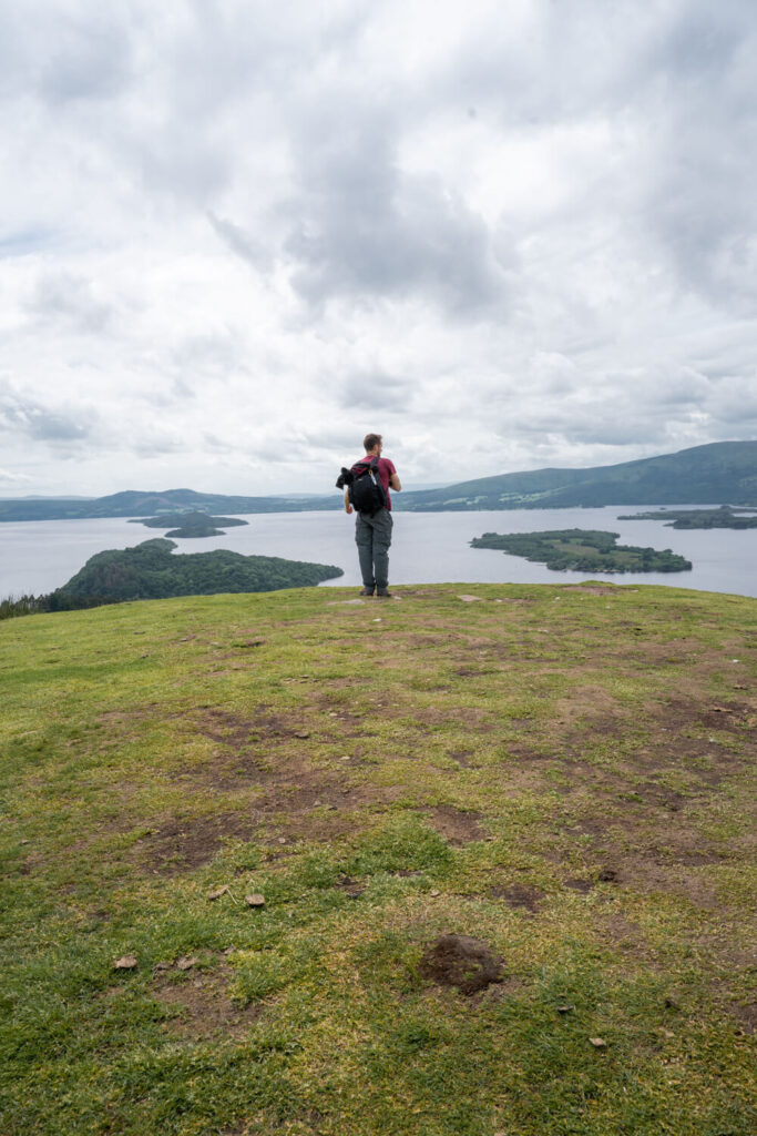 man looking over view of loch lomond