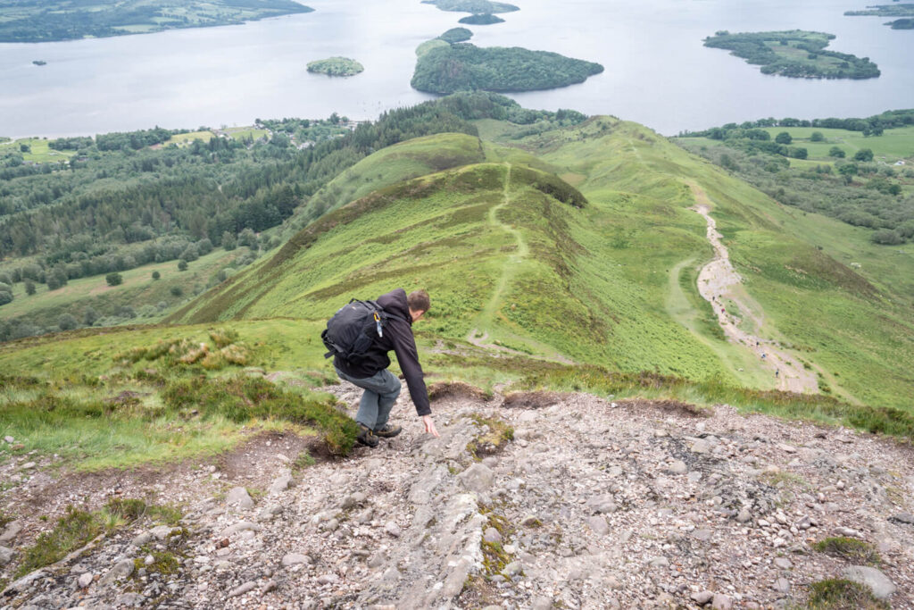 man climbing down hill