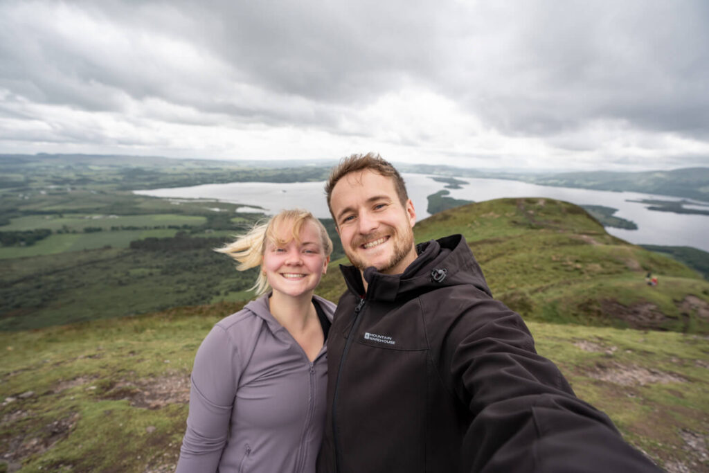 couple selfie at top of conic hill