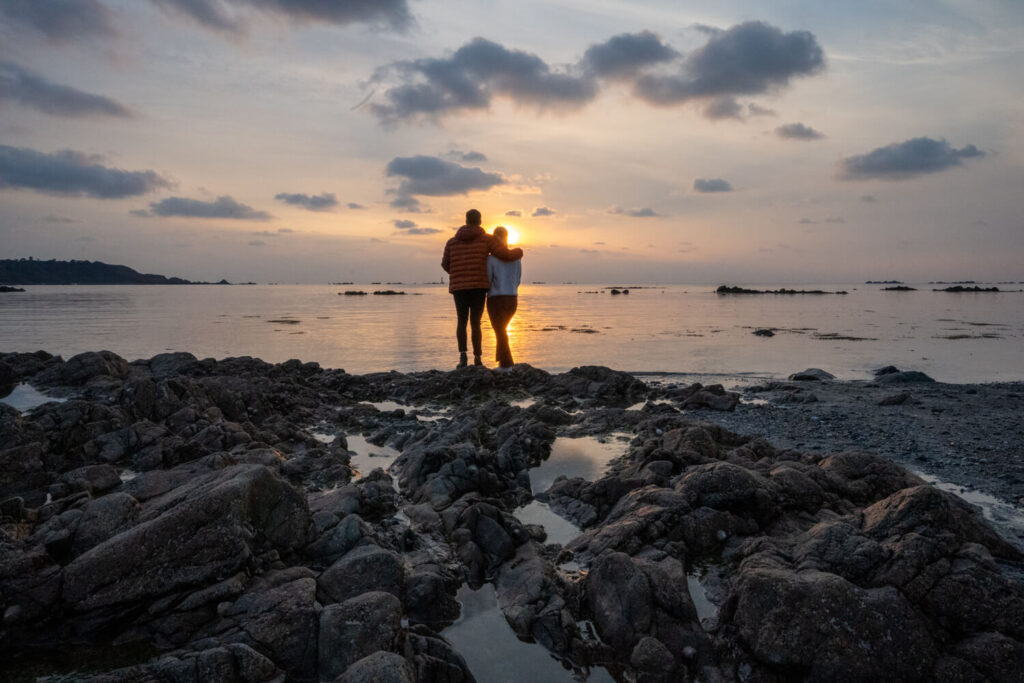 couple watching sunset on leree beach