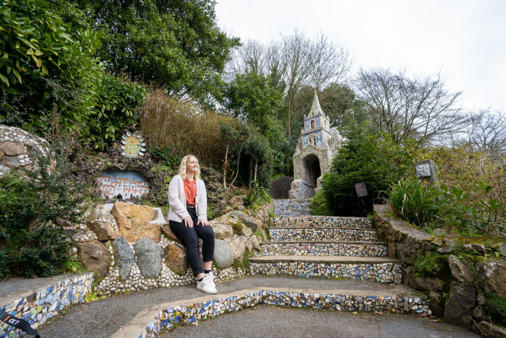 girl sitting in front of little chapel