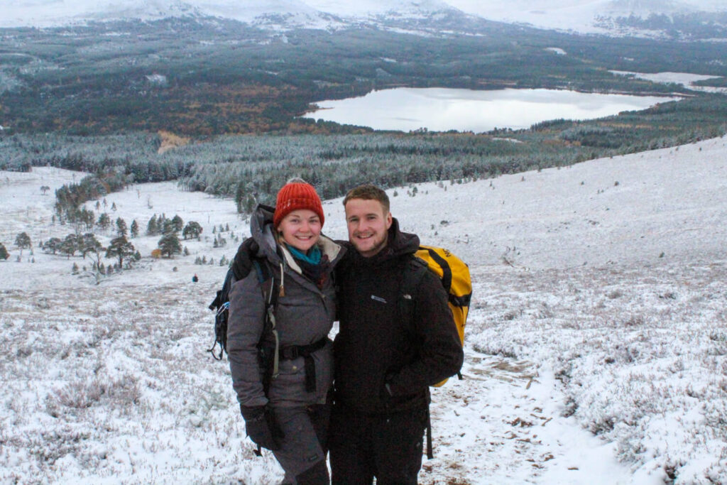 couple on hill with loch view in snow