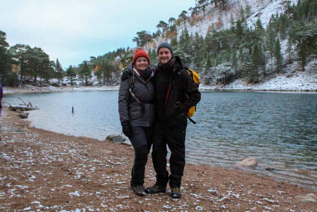 couple standing in front of the green loch