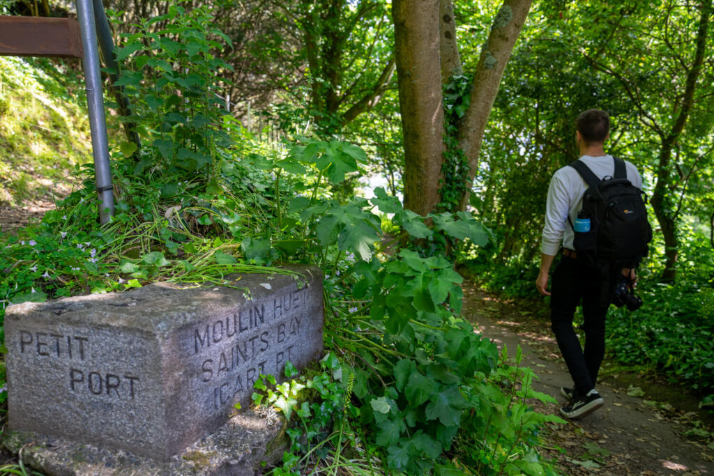 man walking path following sign