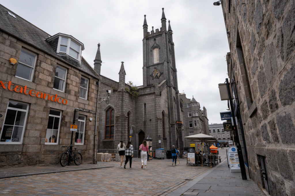 people walking down belmont street aberdeen