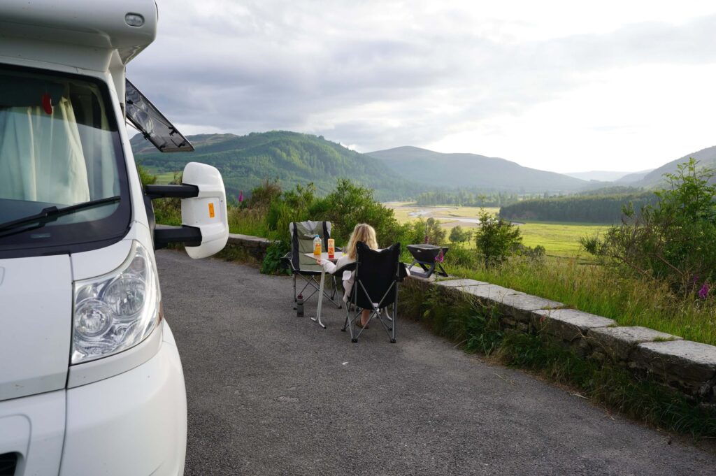 motorhome and girl overlooking glen