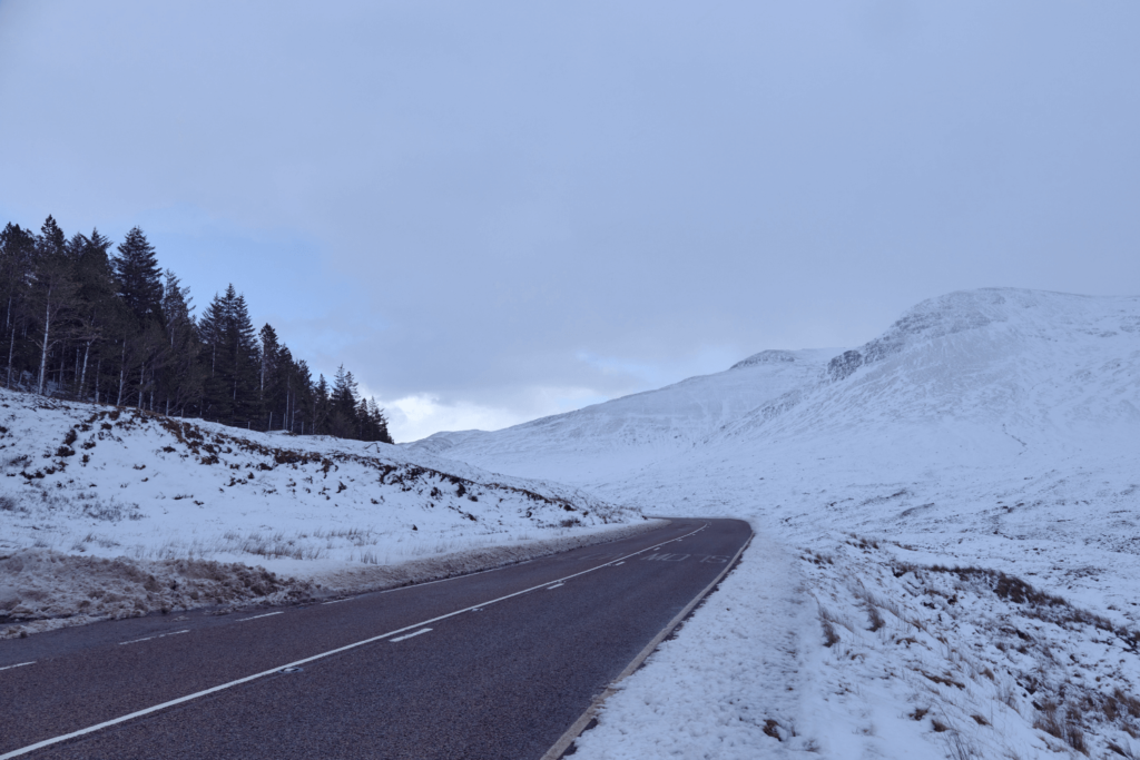 road in scotland surrounded by snow