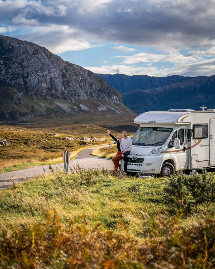 us and our motorhome with mountains in the backdrop
