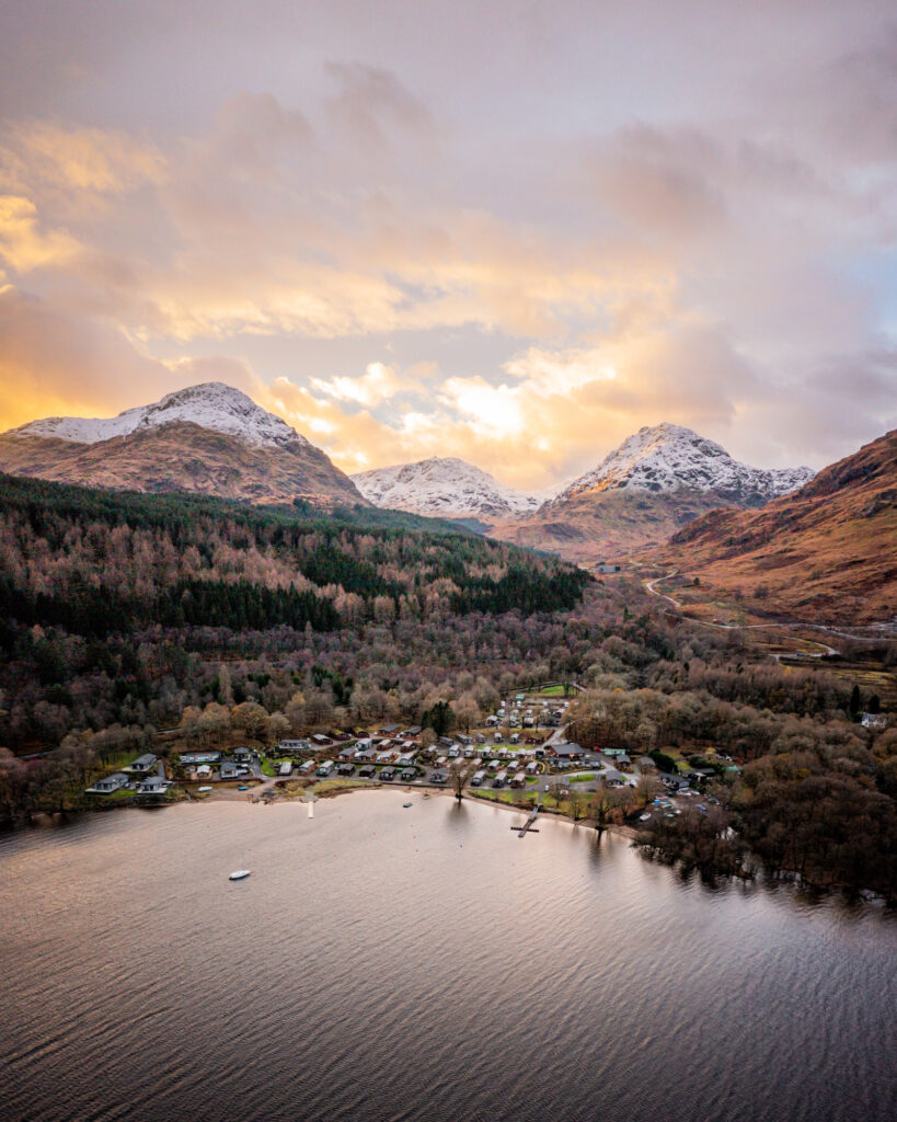 drone photo of scottish mountains and holiday park