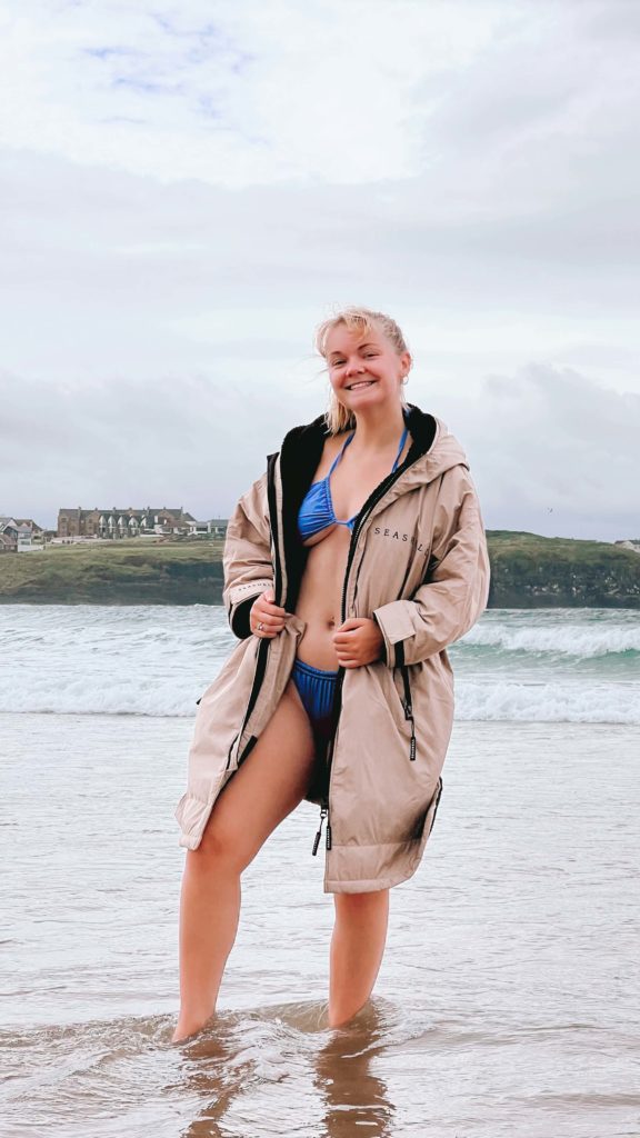 girl standing in seashell swimming robe